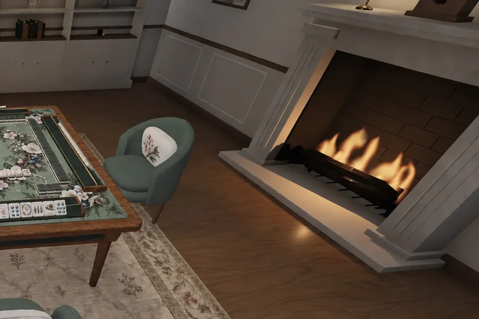 A corner of the game room: the mahjong table, an upholstered chair and a lit fireplace.